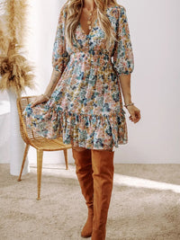 Floral Print Ruffle Hem Mini Dress worn by model, featuring ruffles and floral design, styled with knee-high boots.