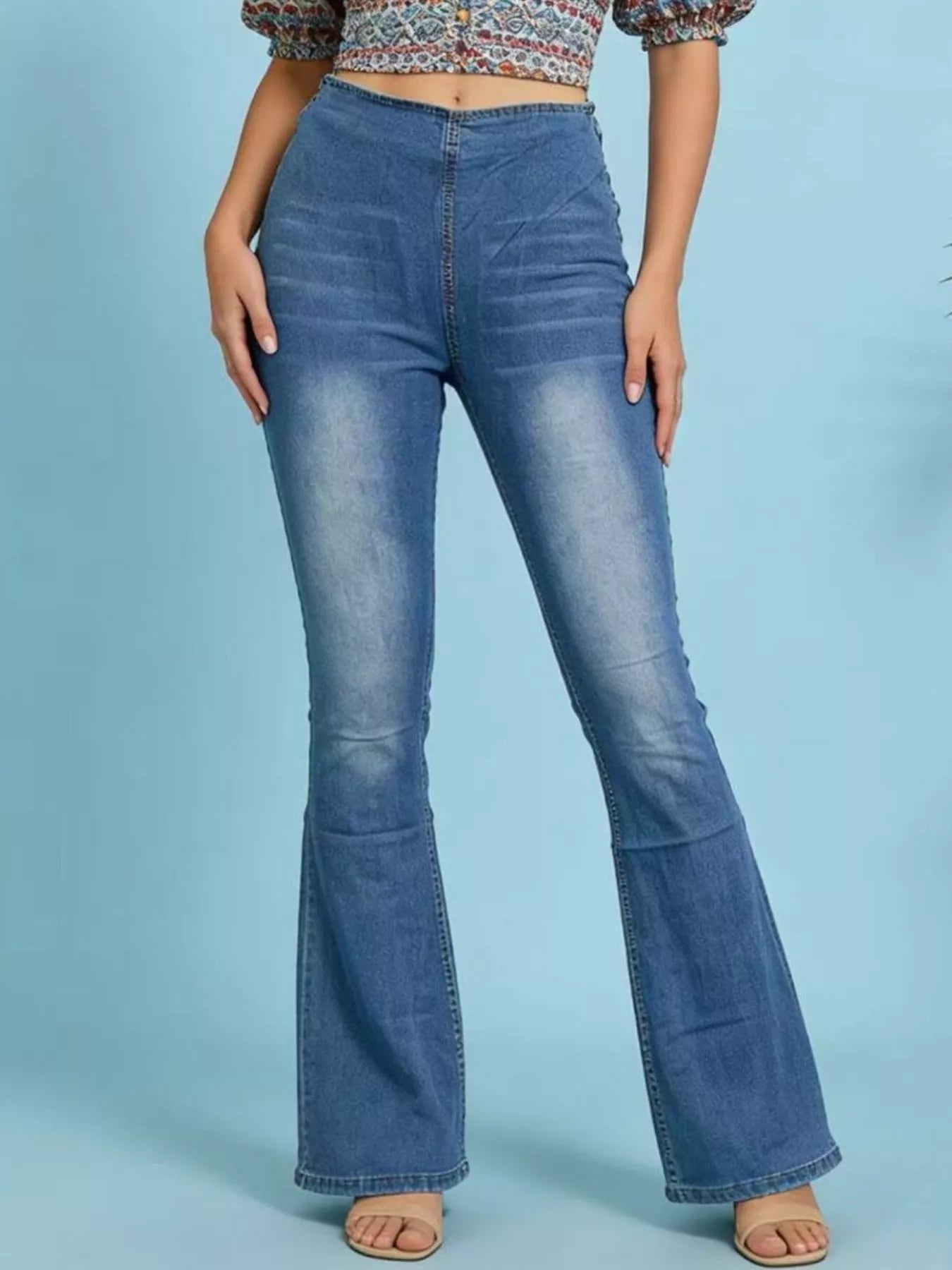 High-Waisted Flare Jeans showcased on model, featuring a flattering fit and slightly stretchy denim material.