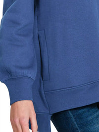 Close-up of the pocket on Zenana Fleece Hi-low Boyfriend Sweatshirts with Pockets, showcasing its relaxed fit and soft fabric.