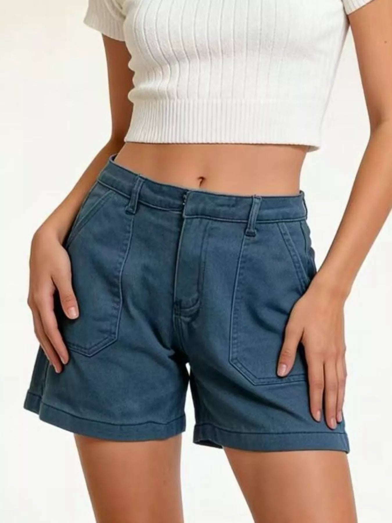 Pocketed Denim Shorts showcased on a model, featuring a stylish design with pockets and a classic fit.