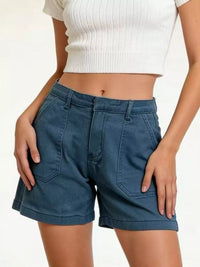 Pocketed Denim Shorts showcased on a model, featuring a stylish design with pockets and a classic fit.