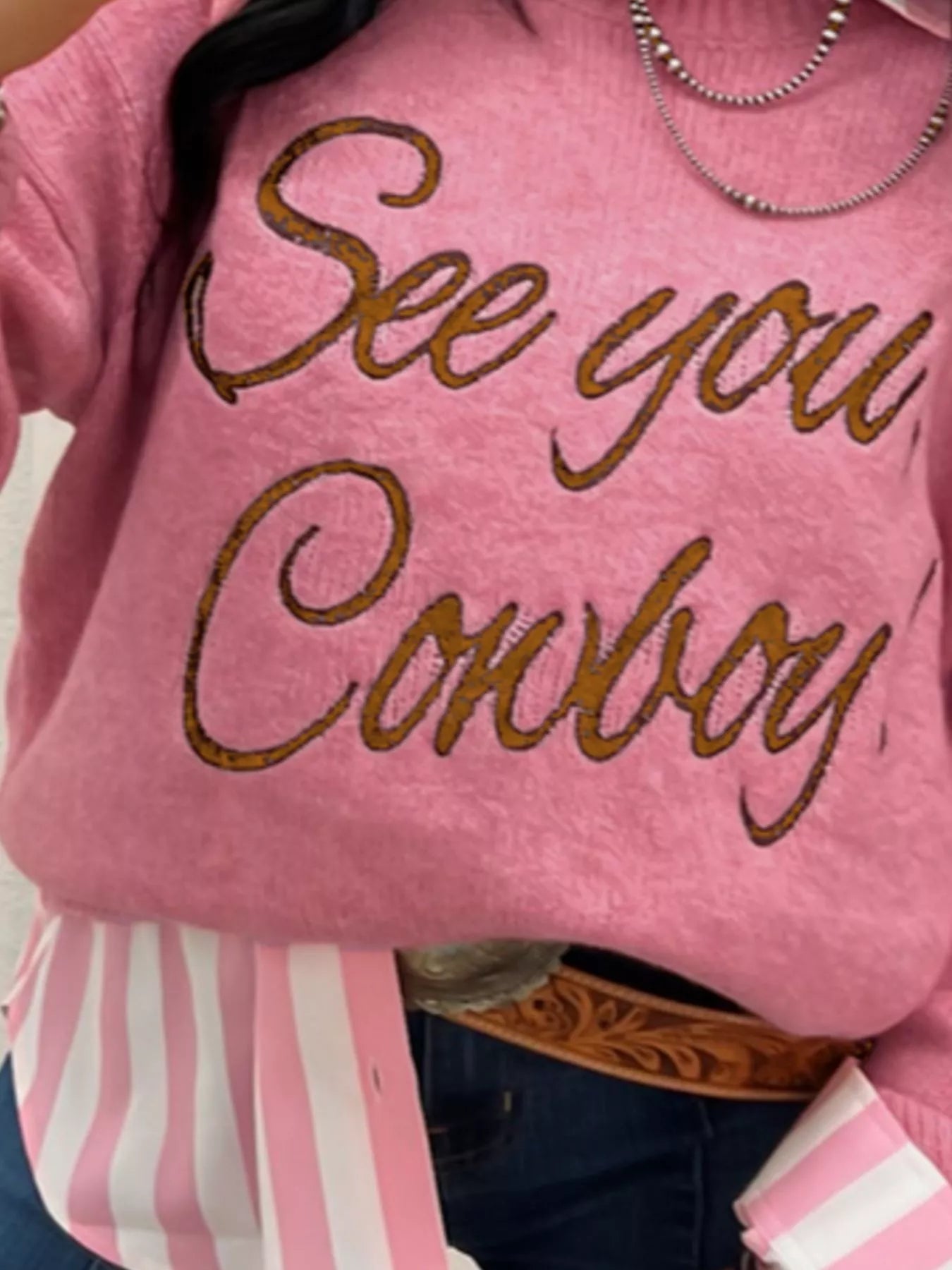 See You Cowboy Round Neck Sweater in pink with glittery lettering for a stylish look.