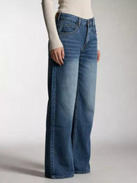 Model wearing Vintage Wash Wide Leg Jeans in a relaxed fit, showcasing a stylish pocketed design.