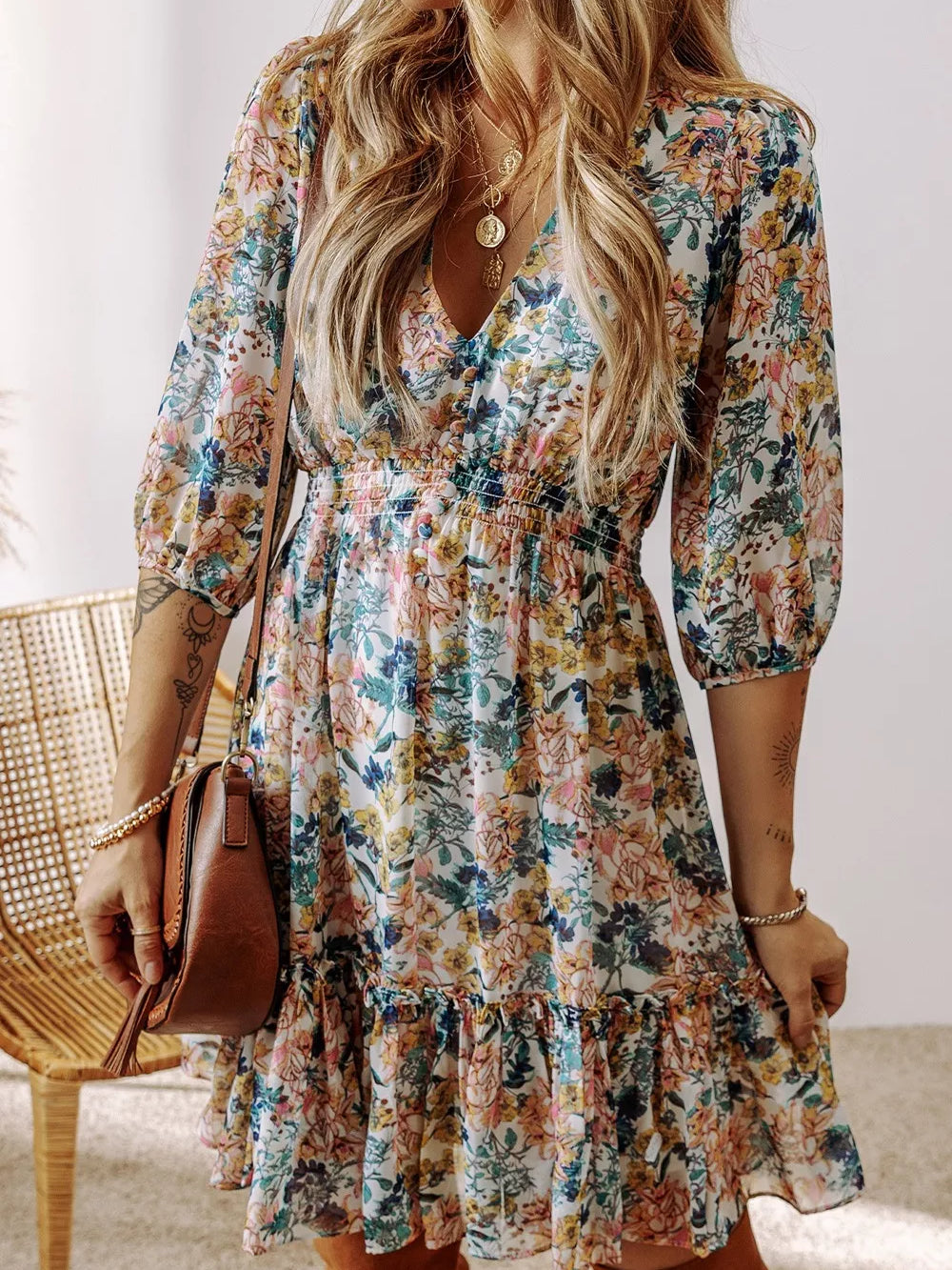 Floral Print Ruffle Hem Mini Dress showcased on a model with long hair, in a colorful floral design with ruffles.