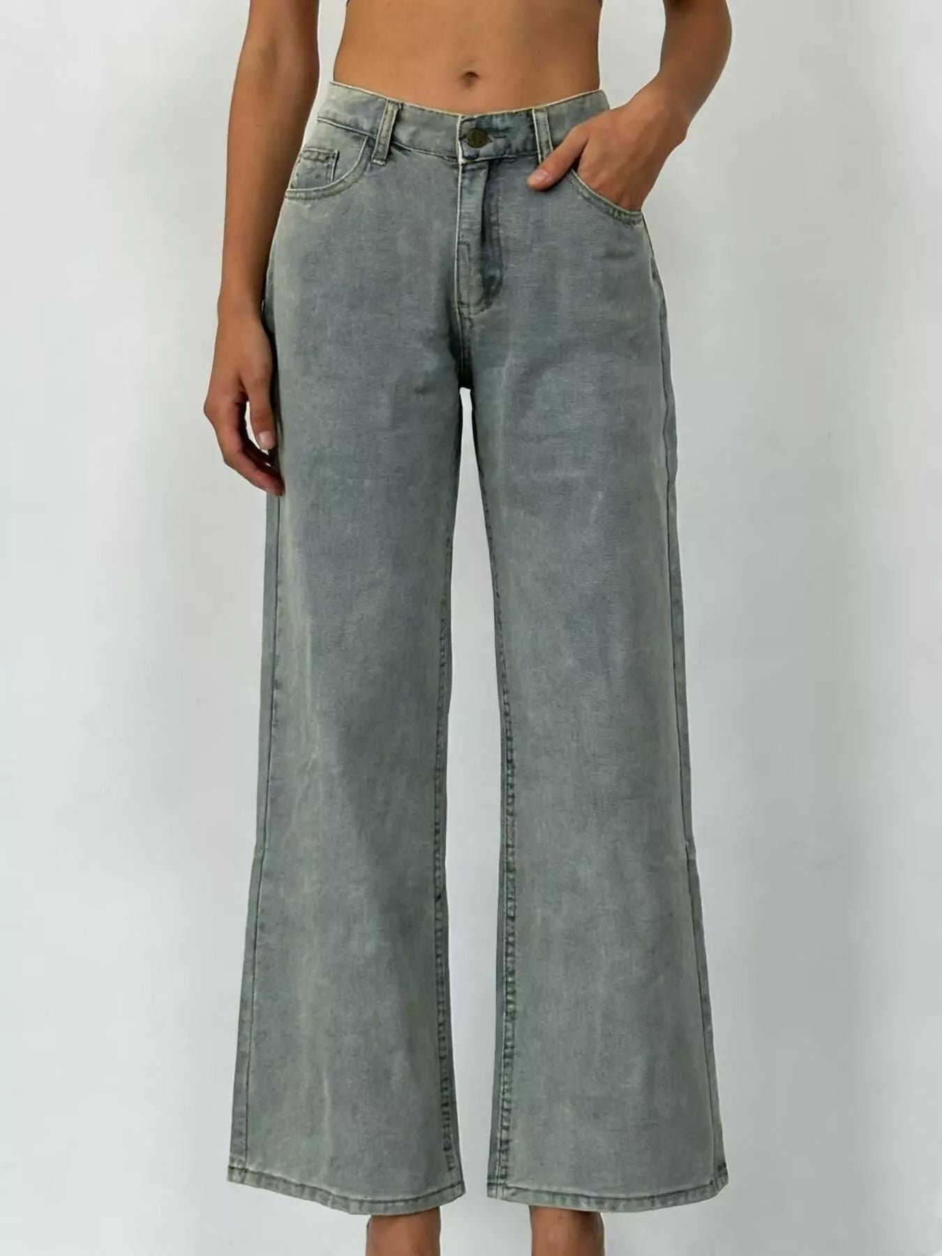 Wide Leg Washed Jeans featuring a pocketed design and a button closure in a light faded color.