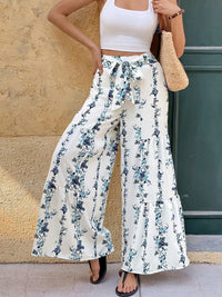 Floral Print Tie Front Wide Leg Pants showcased on a model outdoors, featuring a stylish tied waist and flowing fabric.