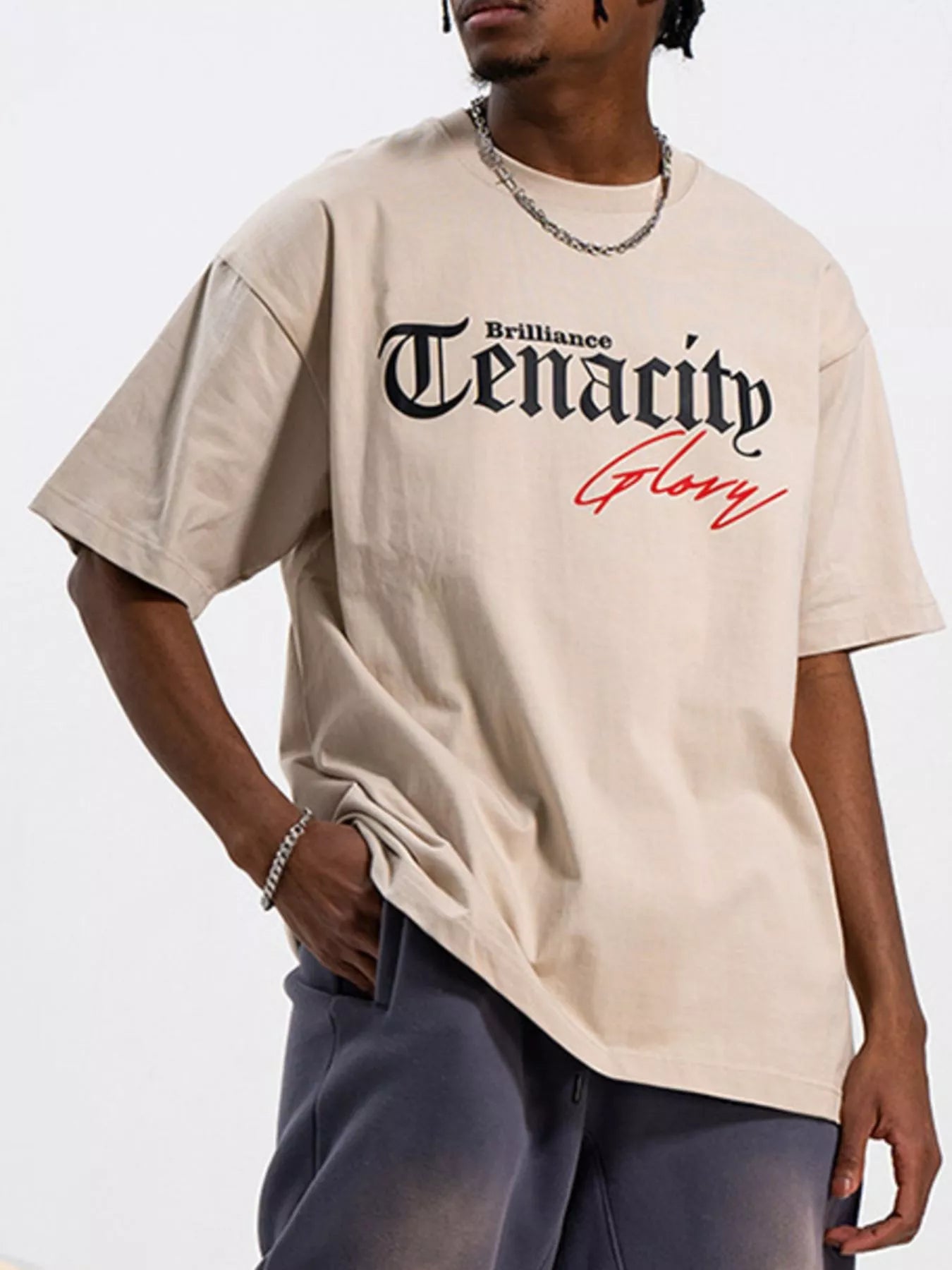 Men's TENACITY Round Neck Short Sleeve T-Shirt in beige with graphic design features, perfect for casual wear.