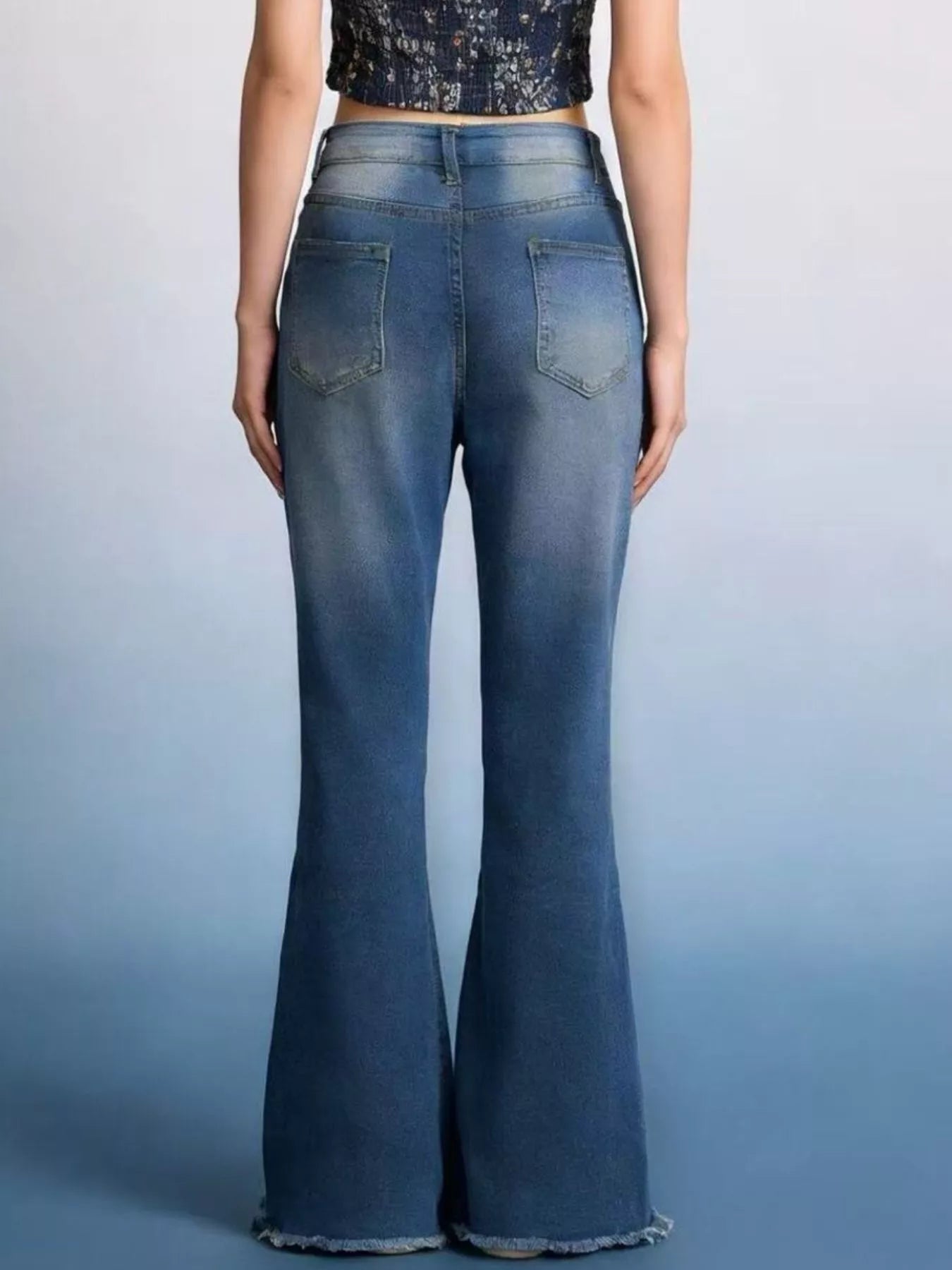 Back view of Raw Hem High-Waisted Flare Jeans showcasing the raw hem and pocketed design.