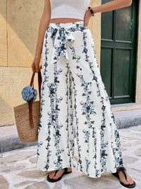 Floral Print Tie Front Wide Leg Pants showcased outdoors with tiered design and tied waistband.