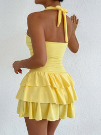 Yellow halter ruffle mini dress, open back with tied neck strap and tiered skirt