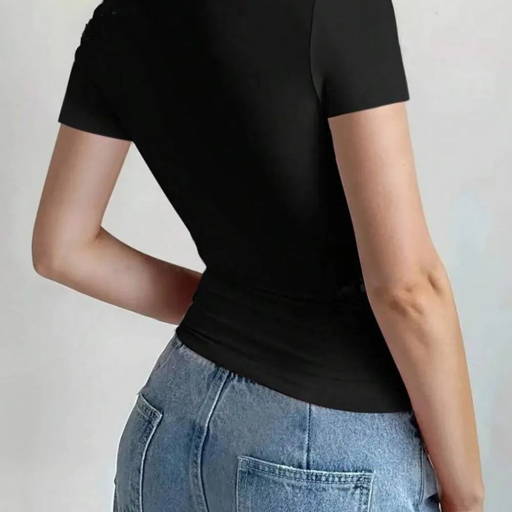 Back view of a woman wearing a Round Neck Short Sleeve T-Shirt in black paired with high-waisted jeans.
