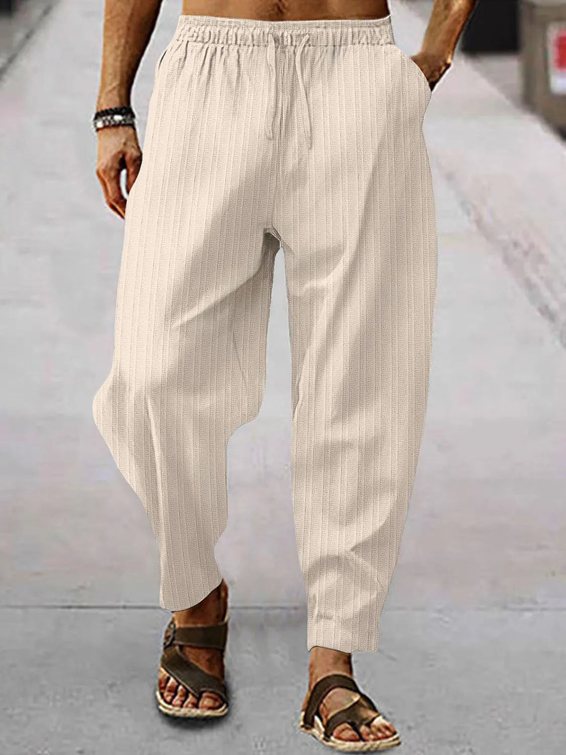 Men's full size drawstring pants with pockets in beige, perfect for casual wear and comfortable styling.