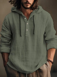 Men's half button hoodie in a green hue, featuring a relaxed fit and long sleeves, perfect for casual wear.