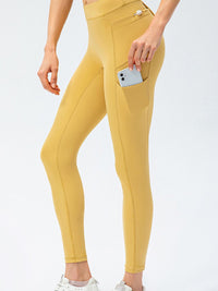 Full Size Slim Fit High Waist Long Sports Pants with Pockets in yellow with side pocket for convenience.