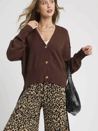 Umgee Button-Front V-Neck Knit Cardigan styled with leopard print pants and a bag, showcasing a chic layered look.