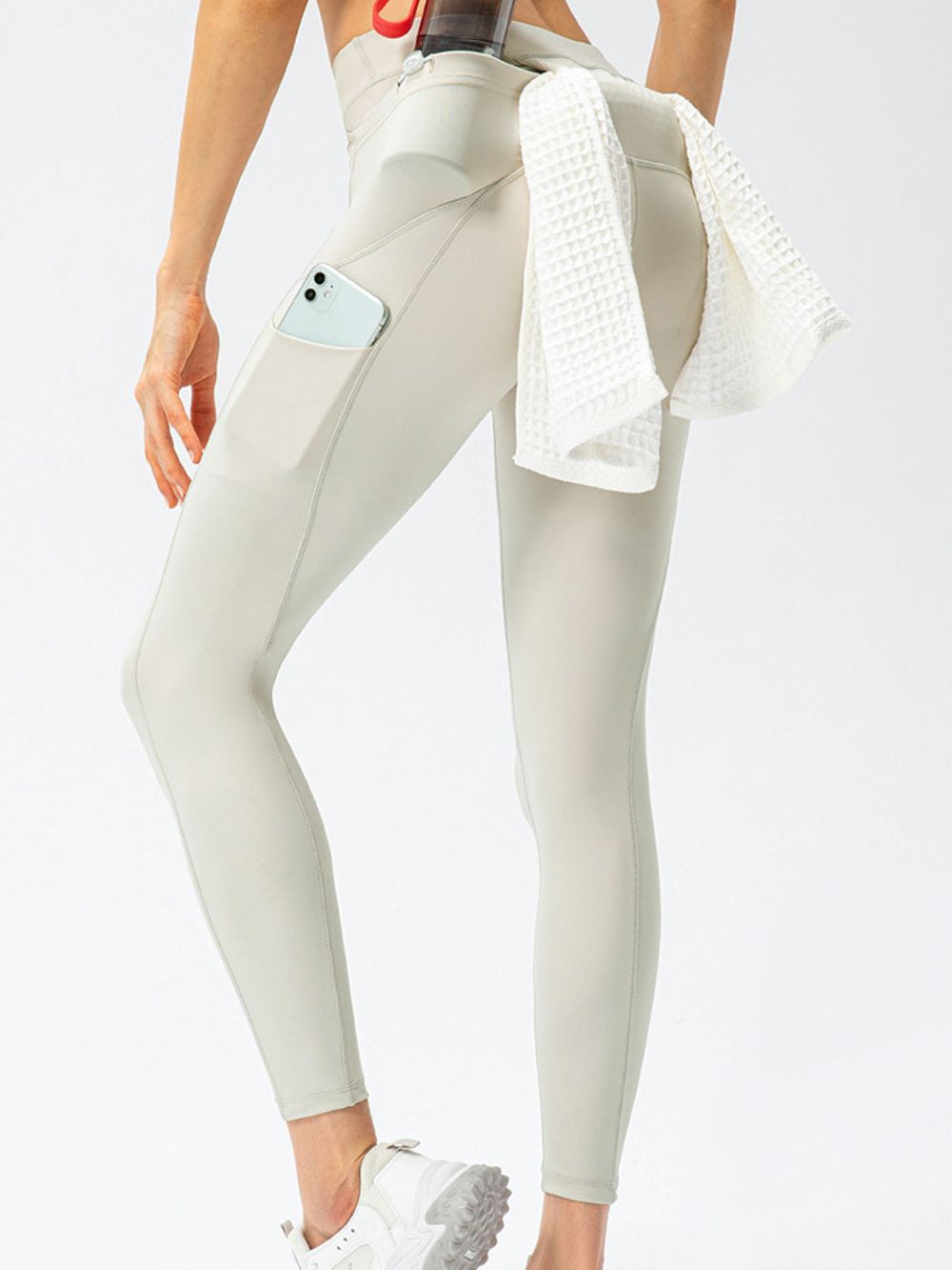 Full Size Slim Fit High Waist Long Sports Pants with Pockets displayed on a model from behind, showing sleek design and practicality.