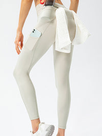 Full Size Slim Fit High Waist Long Sports Pants with Pockets displayed on a model from behind, showing sleek design and practicality.