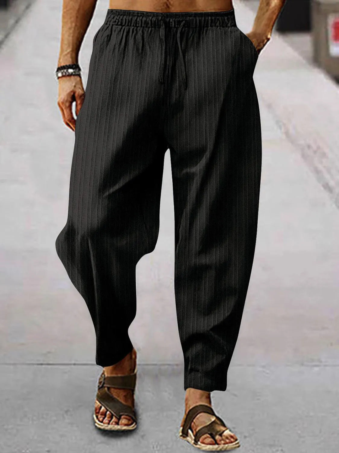 Men's full-size plus size drawstring pants with pockets in black striped design, perfect for casual wear.