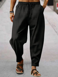 Men's full-size plus size drawstring pants with pockets in black striped design, perfect for casual wear.