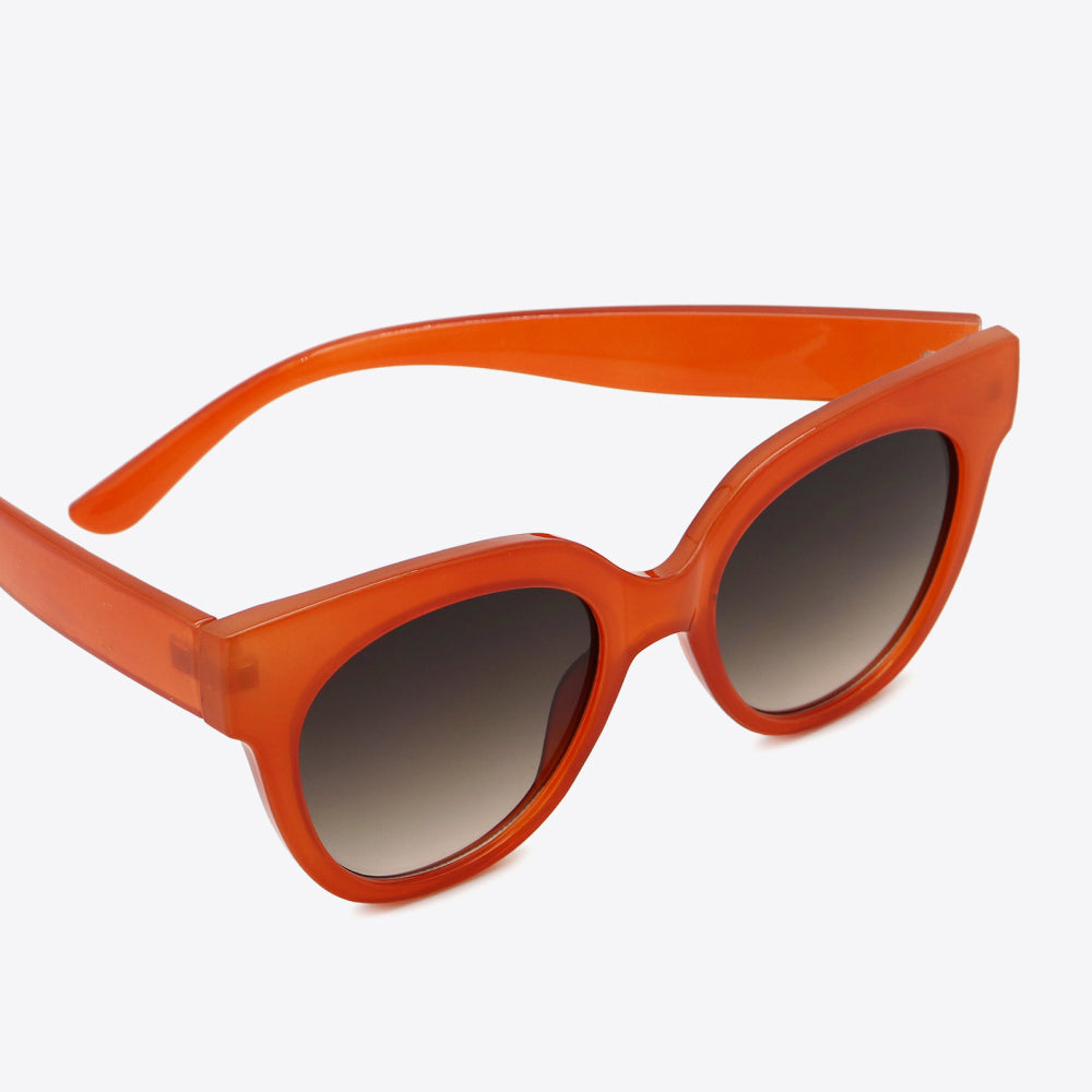 Stylish UV400 Polycarbonate Round Sunglasses in vibrant orange color with gradient lenses.