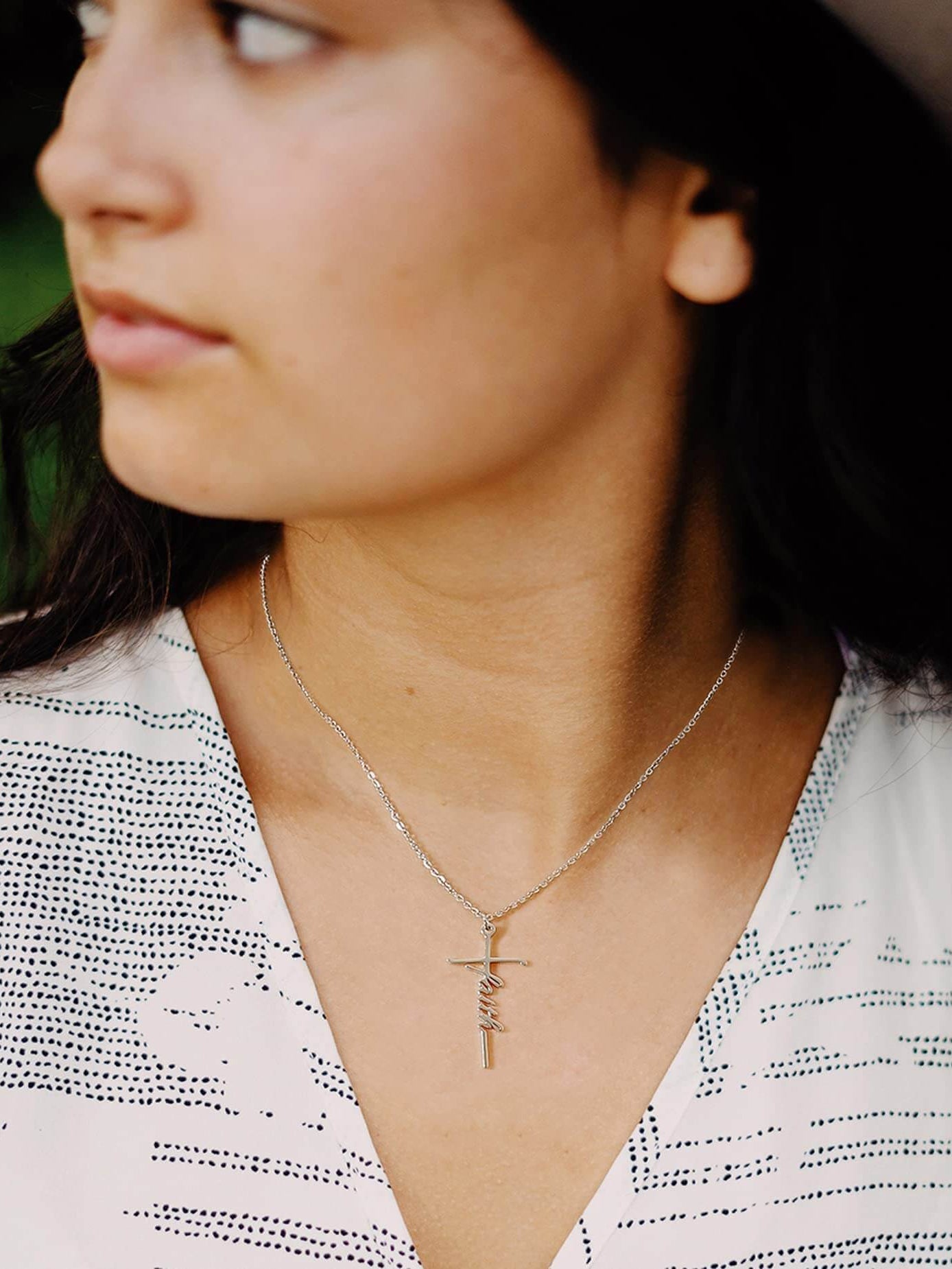 Woman wearing Lcherry Faith Cross Necklace, showcasing elegant religious jewelry and personal expression of faith.