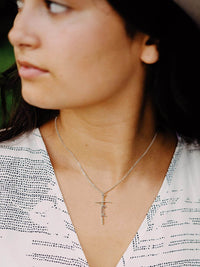 Woman wearing Lcherry Faith Cross Necklace, showcasing elegant religious jewelry and personal expression of faith.