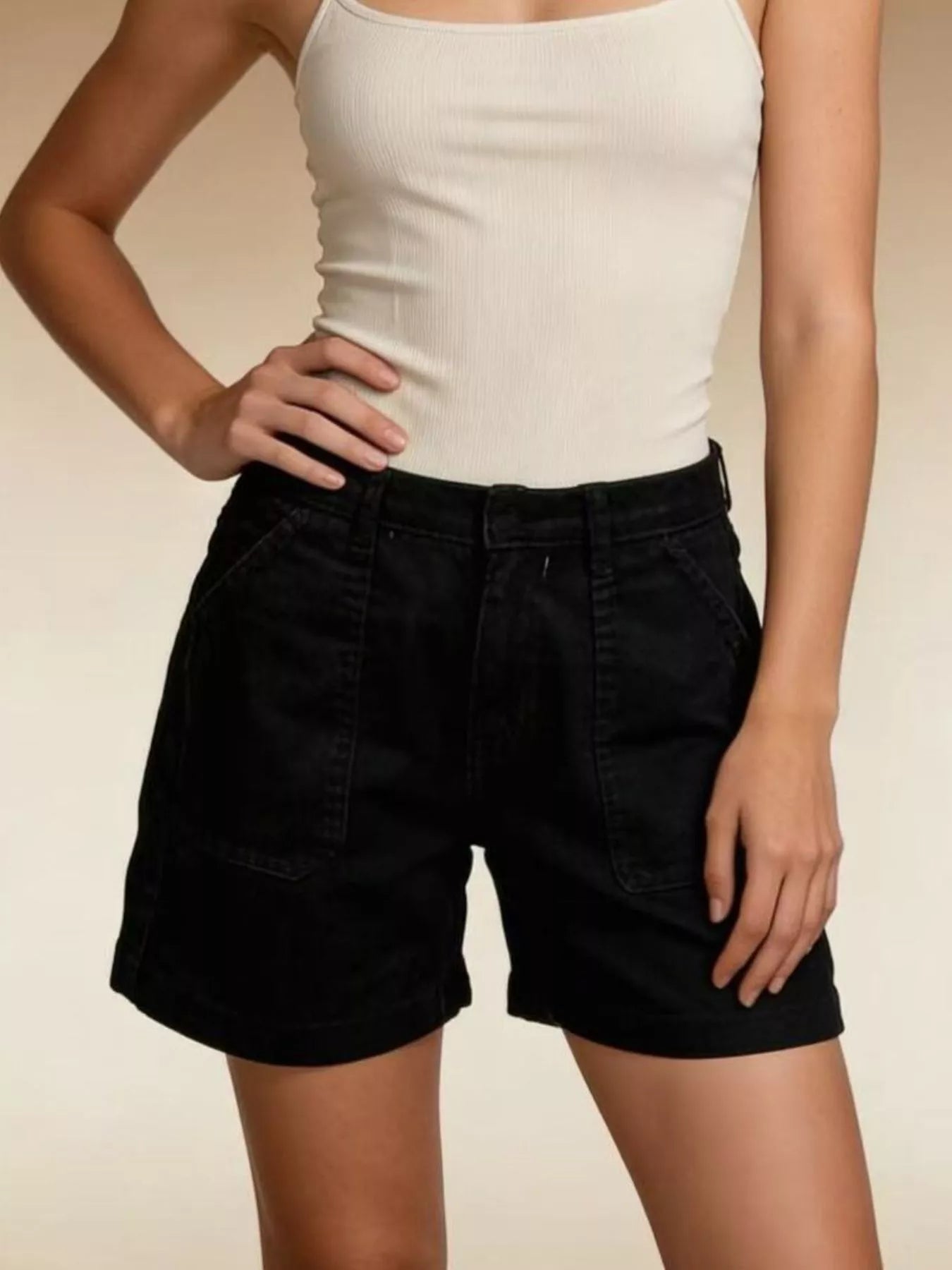 Model showcasing Pocketed Denim Shorts in black, paired with a fitted tank top, highlighting a casual summer look.