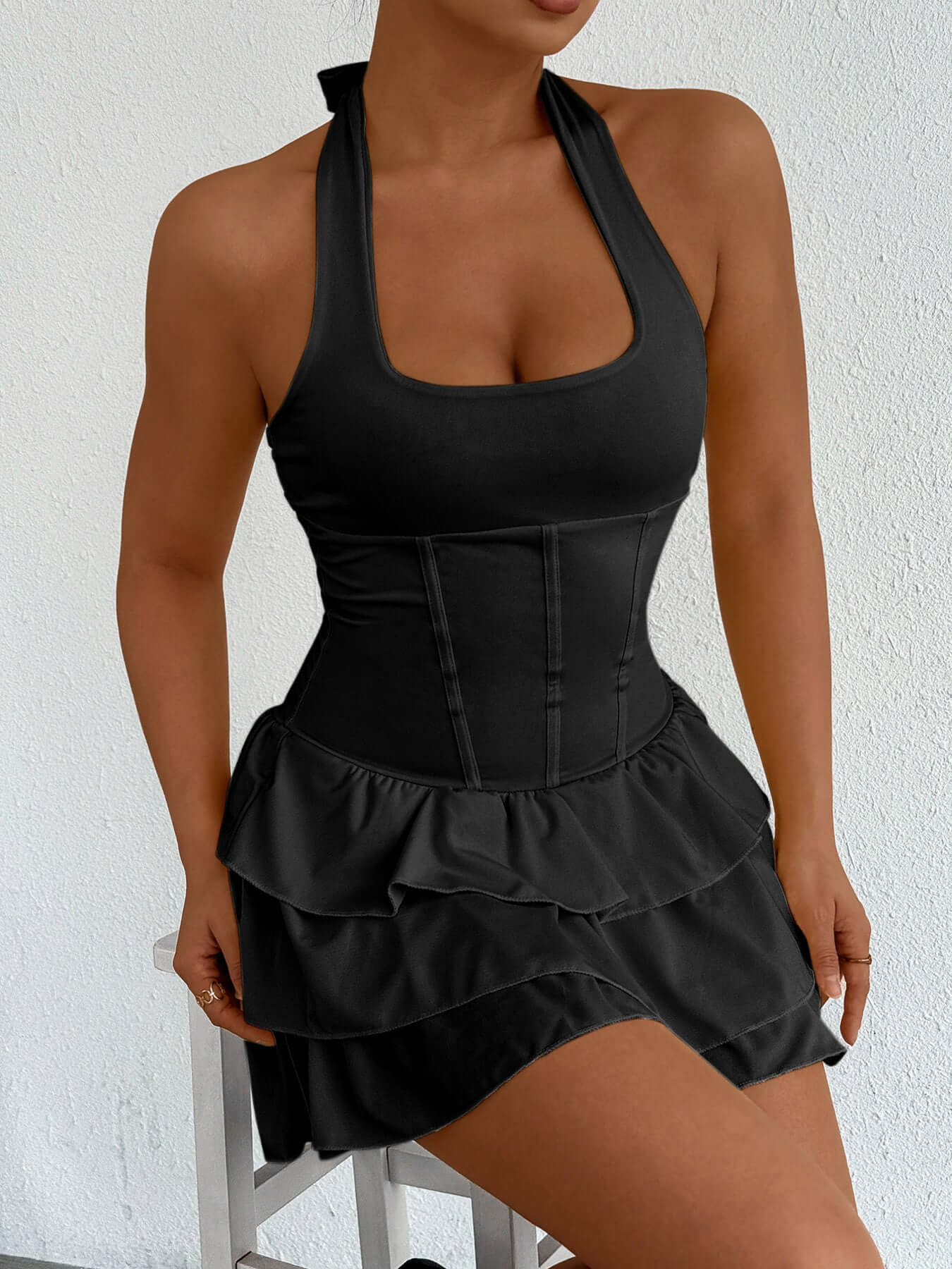 Black halter neck ruffle layered mini dress with tiered skirt and strappy back
