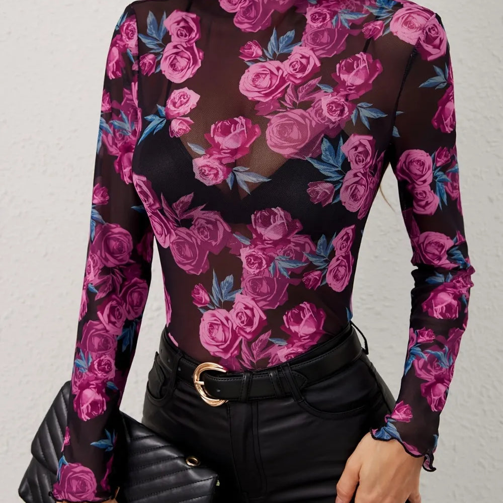 Floral Mock Neck Long Sleeve Top featuring a sheer floral design, model styled with a black handbag and fitted pants.