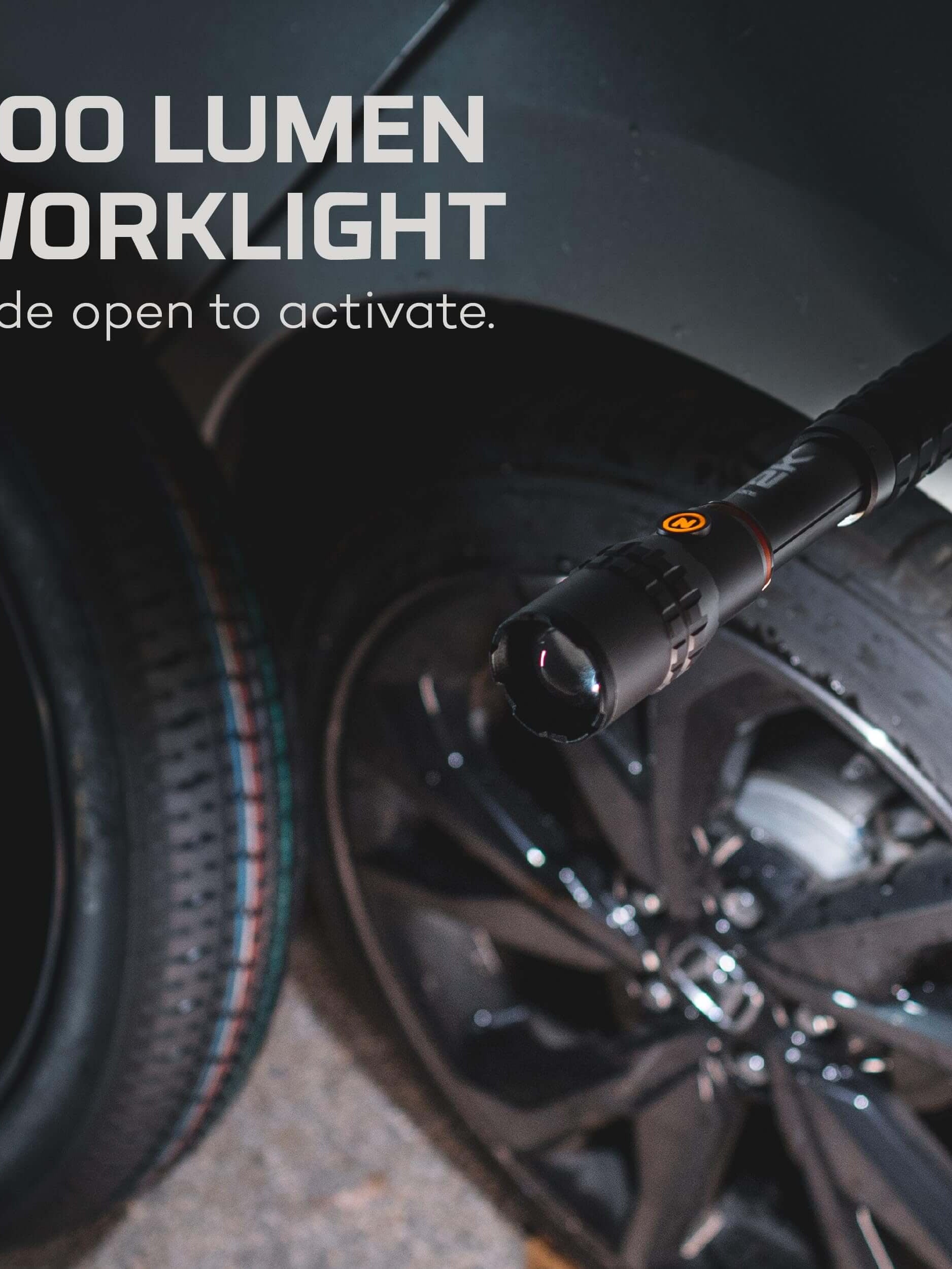500 lumen worklight activated by sliding, mounted on a vehicle next to a black wheel.