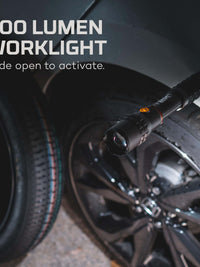 500 lumen worklight activated by sliding, mounted on a vehicle next to a black wheel.