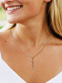 Woman wearing Lcherry Faith cross necklace, showcasing the elegant design and meaningful message of faith.