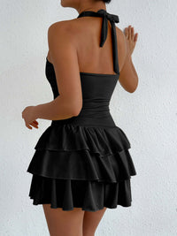 Black halter ruffle mini dress, open back with tied neck strap and tiered skirt