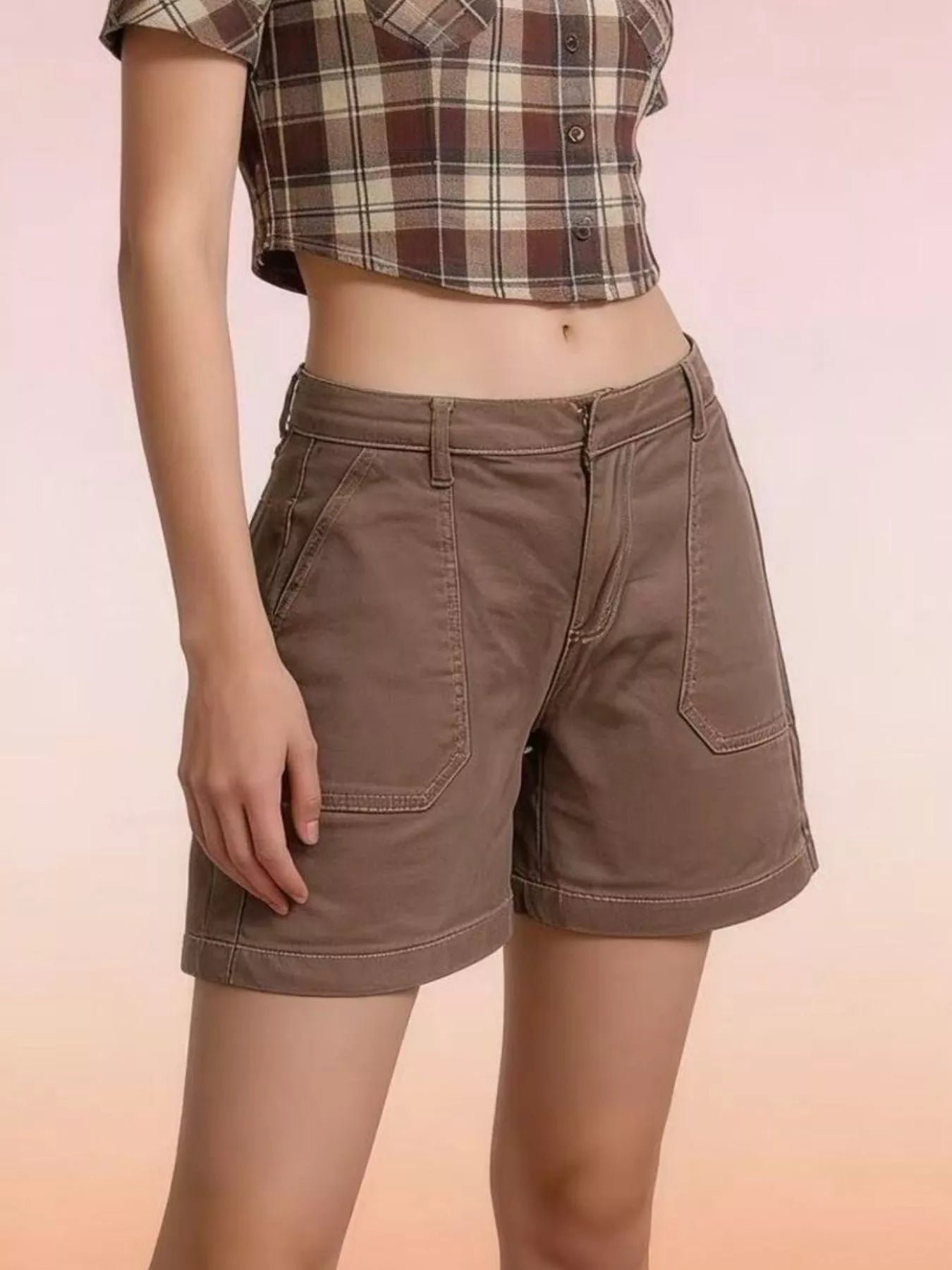 Pocketed Denim Shorts worn by model, featuring a buttoned design and front pockets.