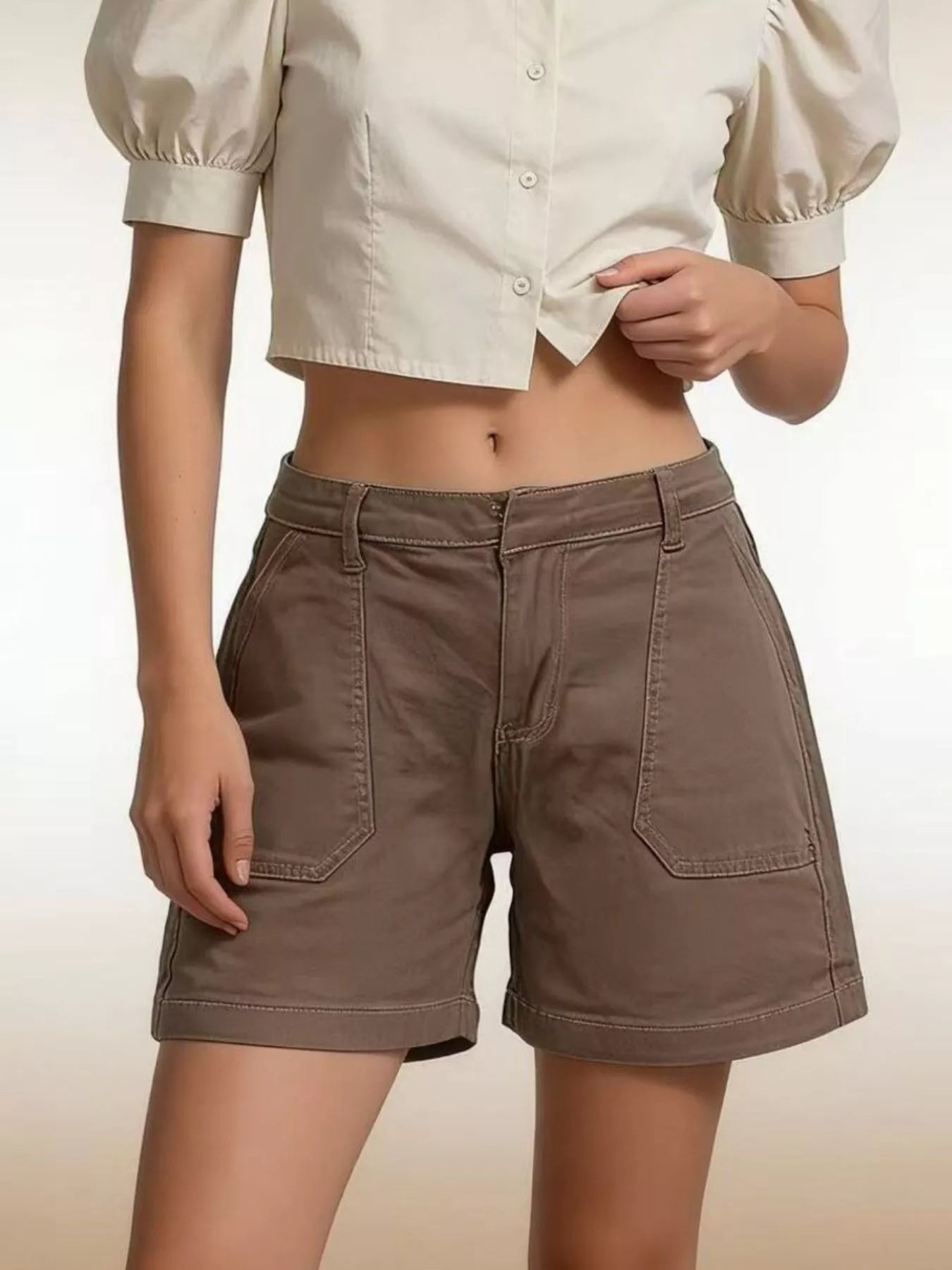 Model wearing Pocketed Denim Shorts in brown, featuring front pockets and stylish look for summer.