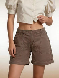 Model wearing Pocketed Denim Shorts in brown, featuring front pockets and stylish look for summer.