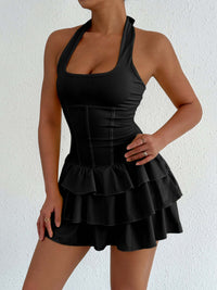 Black halter neck ruffle layered mini dress with tiered skirt and corset-style seams