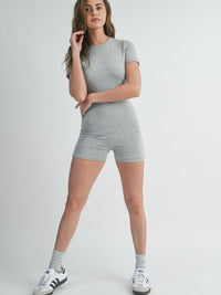 Model wearing a Solid Color Bodycon Jumpsuit in gray, showcasing its stylish and flattering fit.