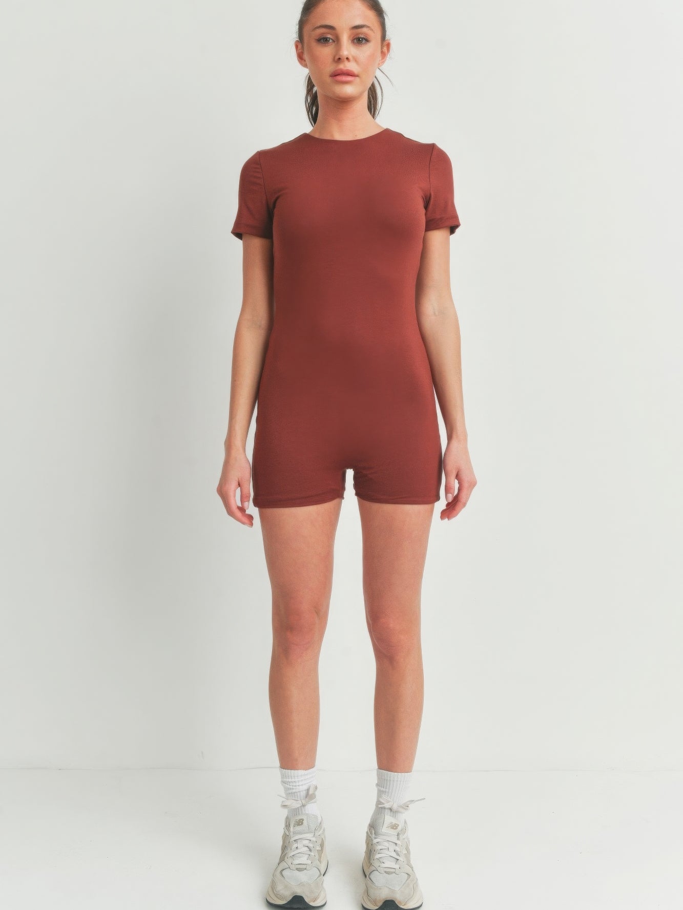 Solid Color Bodycon Jumpsuit in rust color, showcasing a flattering fit and stylish design, perfect for casual wear.