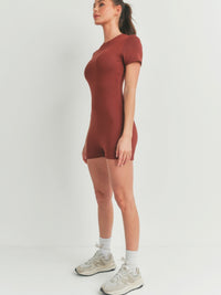 Model wearing a Solid Color Bodycon Jumpsuit in brown, showcasing its flattering fit and stylish design.