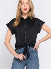 Model wearing Short Slv Front Tie Stretch ITY Top in black, showcasing its stylish front tie and short sleeves.