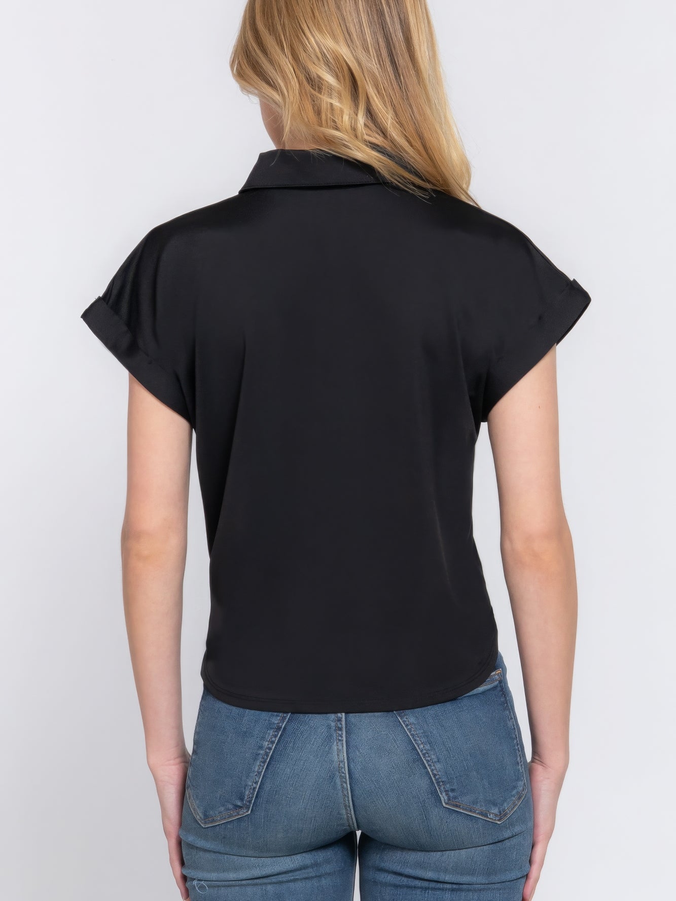 Back view of a woman wearing a Short Slv Front Tie Stretch ITY Top, showcasing its smooth fabric and stylish design.