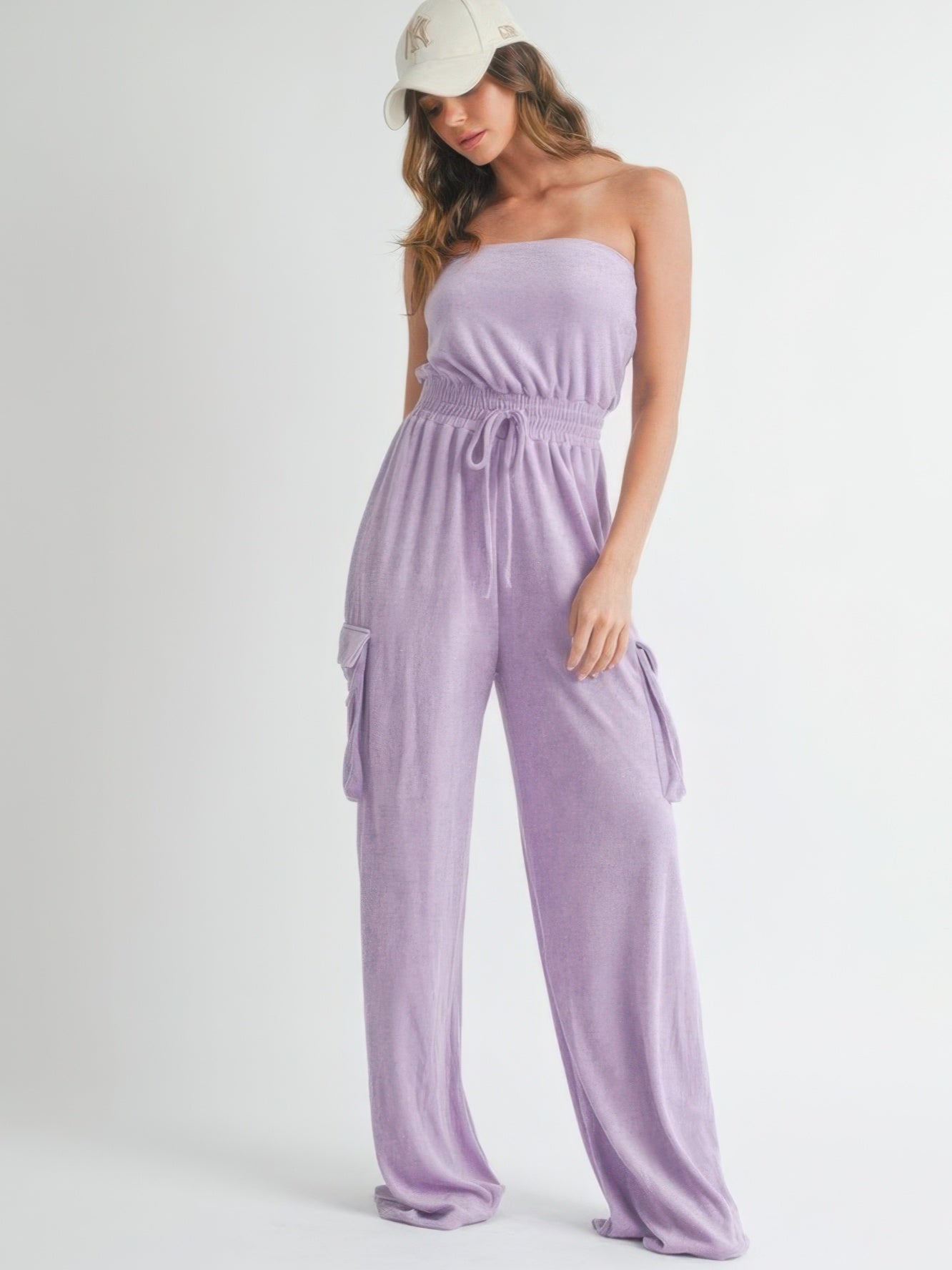 Model wearing a stylish Tube Top Jumpsuit Romper in lavender with a cap, perfect for casual outings.
