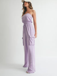Woman wearing a Tube Top Jumpsuit Romper in lavender with pockets and a cap, showcasing effortless summer style.