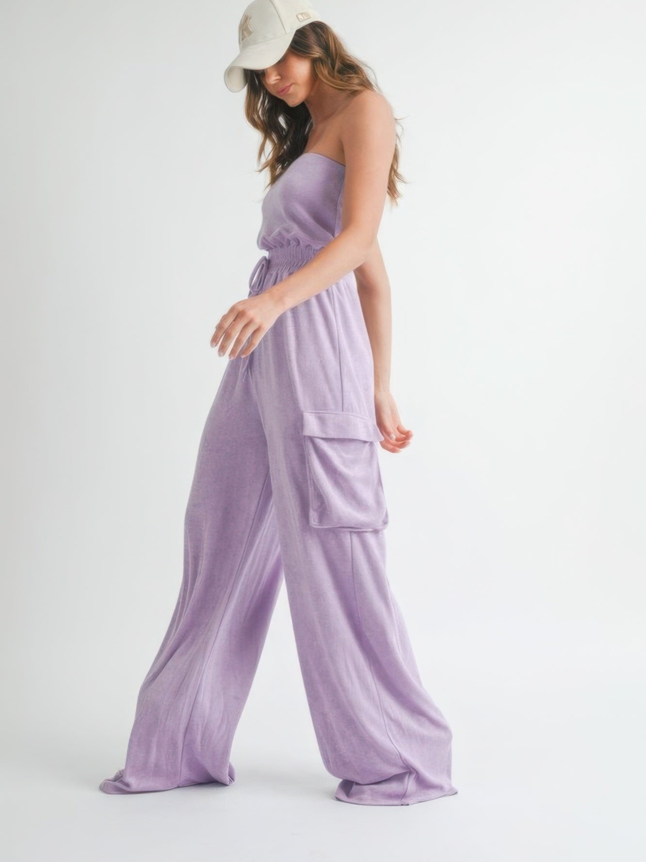Model wearing a stylish Tube Top Jumpsuit Romper in lavender color, showcasing relaxed summer vibes.