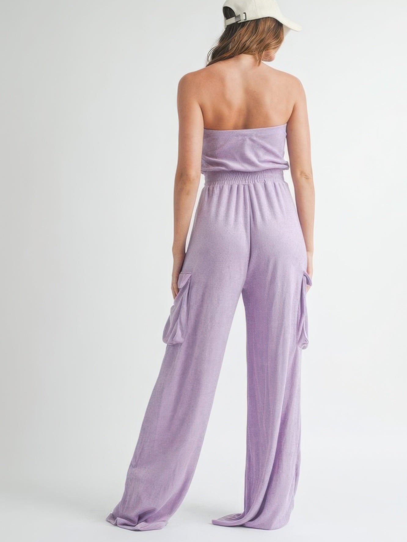 Back view of a woman wearing a Tube Top Jumpsuit Romper in lavender, showcasing its relaxed fit and casual style.