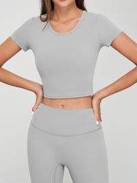 Model wearing a grey seamless crop tee with short sleeves and matching high-waisted bottoms.