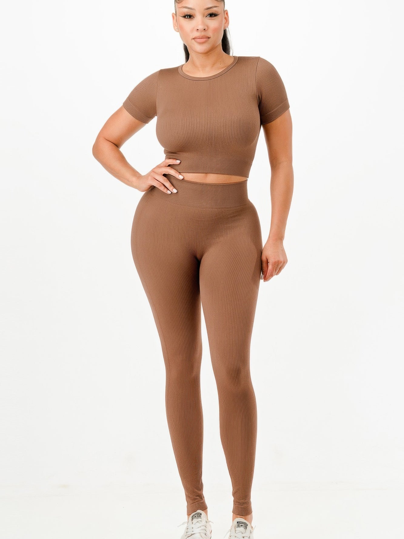 Ribbed seamless activewear set featuring a cropped T-shirt and high-waist leggings in a rich brown color.