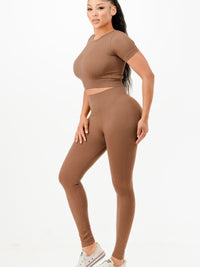 Ribbed seamless activewear set featuring a cropped T-shirt and high-waist leggings in a comfortable brown fabric.