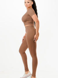 Ribbed seamless activewear set featuring a cropped T-shirt and high-waist leggings in a soft, stretchy fabric.